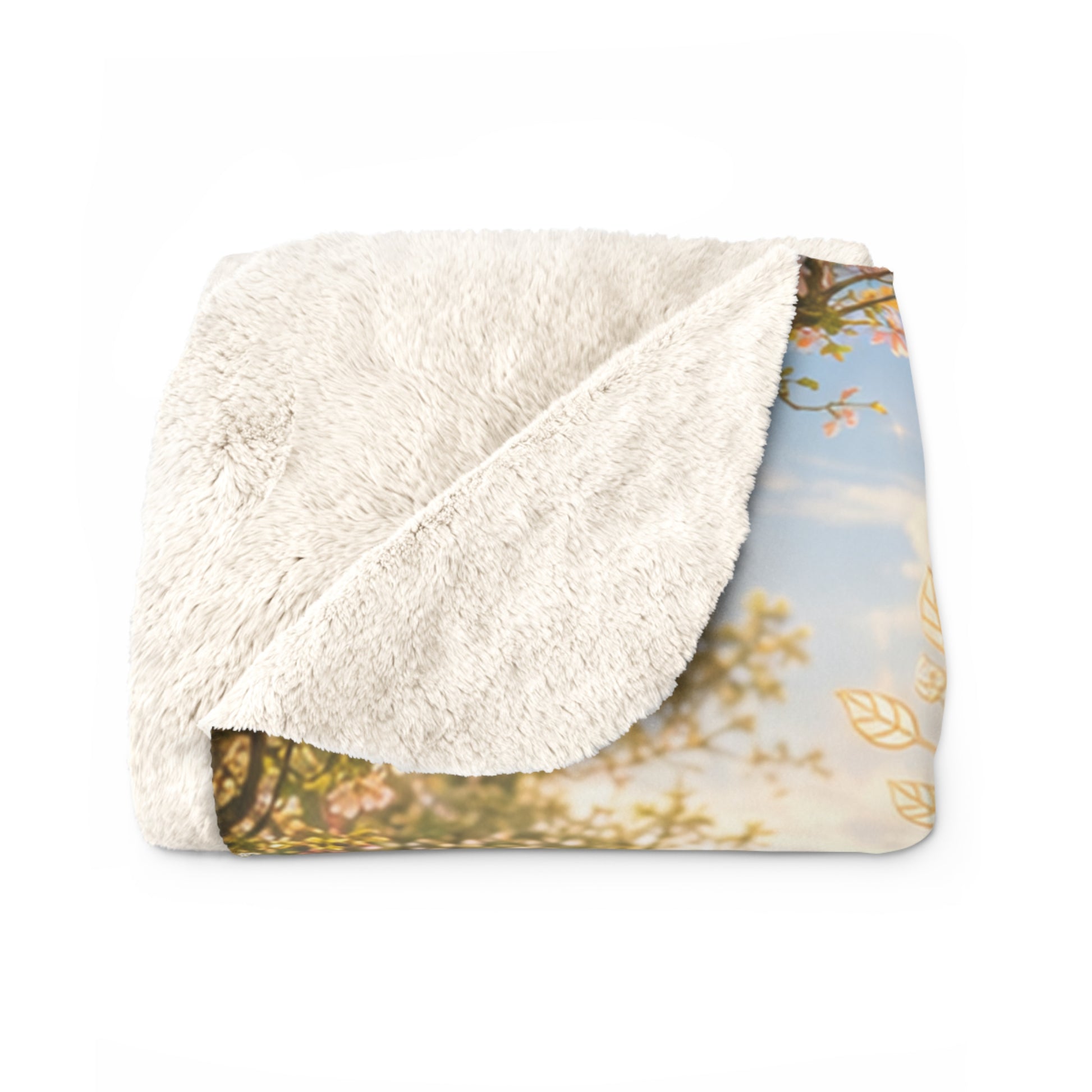 Gefaltete Goldhain-Kuscheldecke mit farbig bedruckter Vorderseite und flauschiger cremefarbener Sherpa-Rückseite